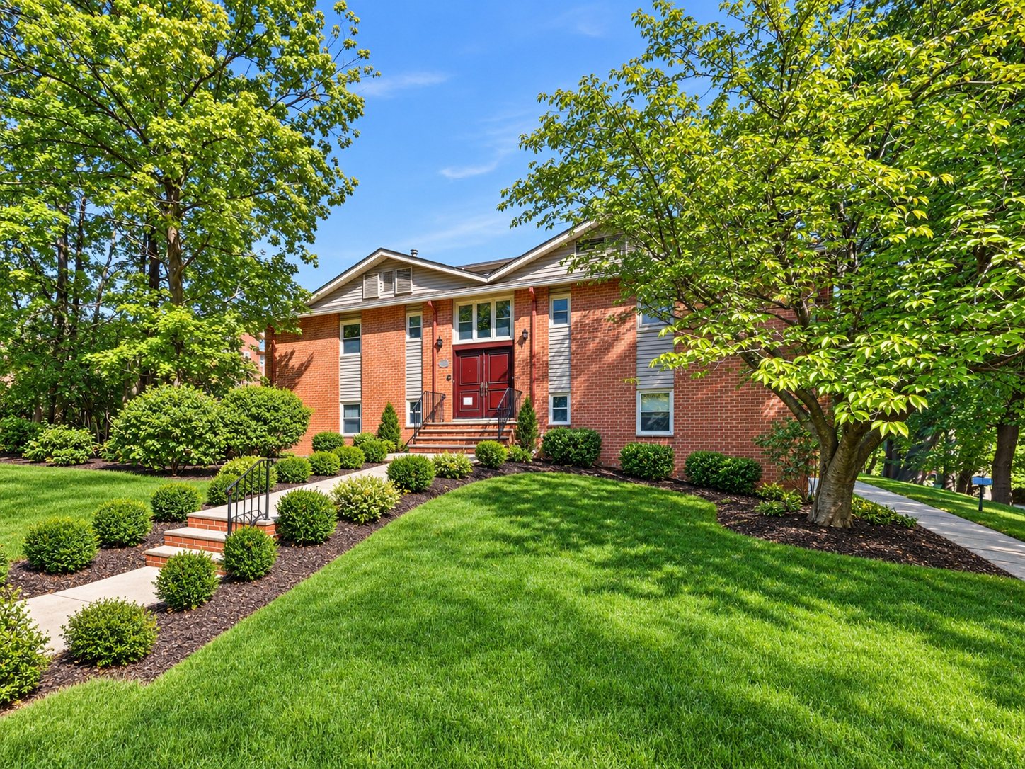 Brick facade and landscaped lawn at Upper Mountain Gardens, 361 Claremont Avenue, Montclair