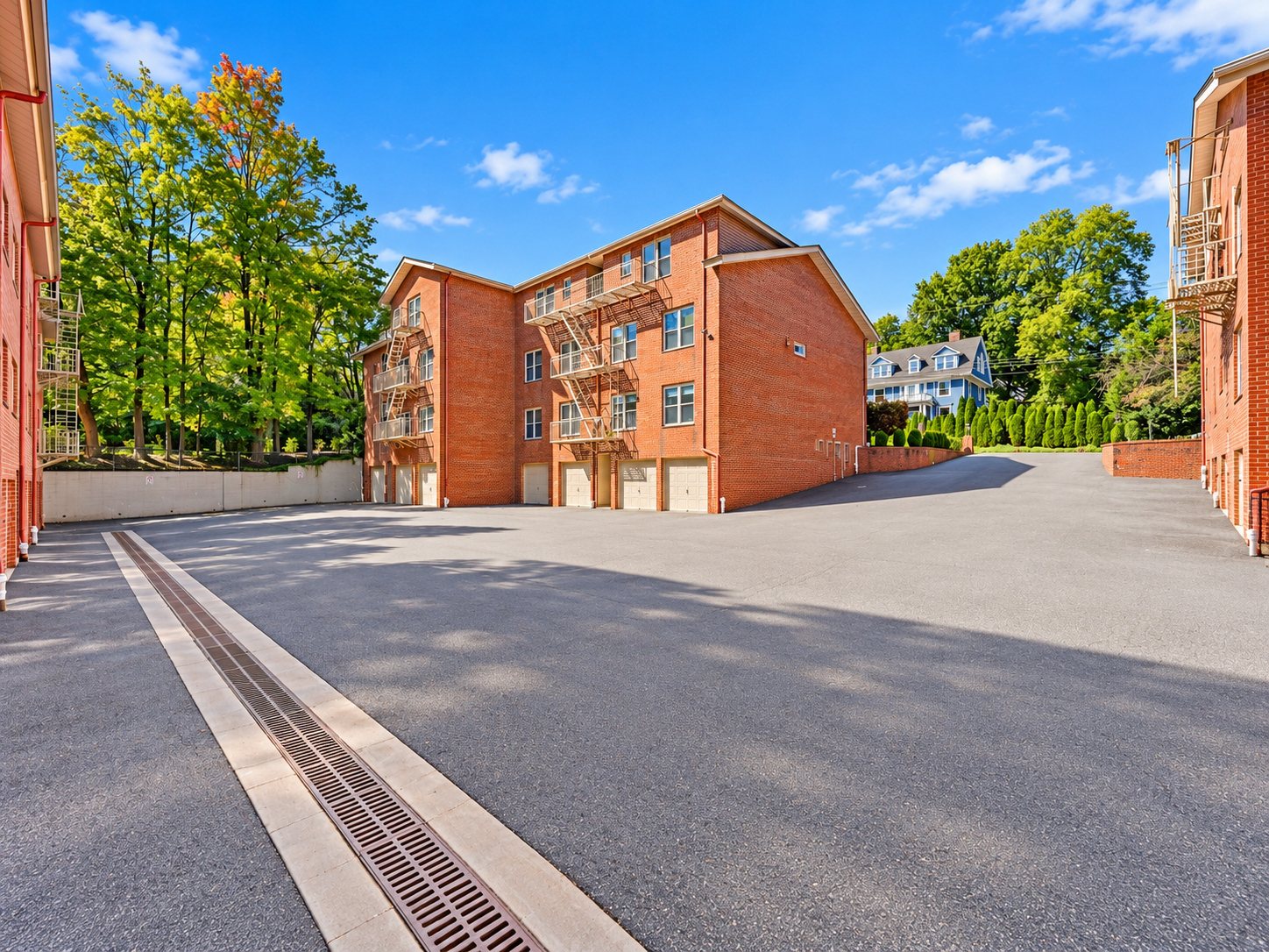 Parking courtyard between the brick buildings of Upper Mountain Gardens